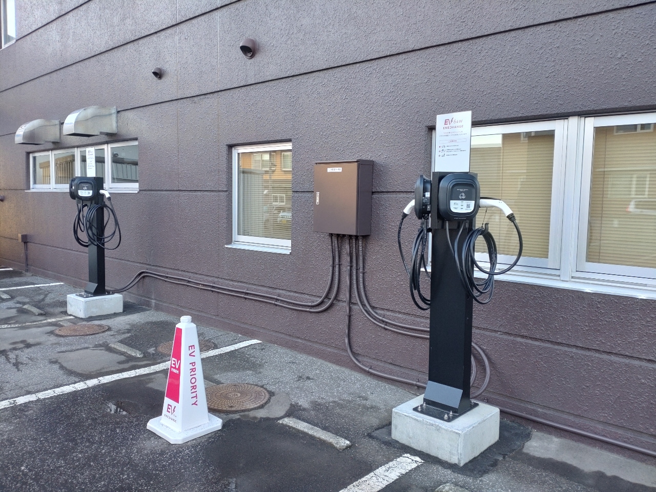 EV charging stations are located in the parking lot behind the hotel.